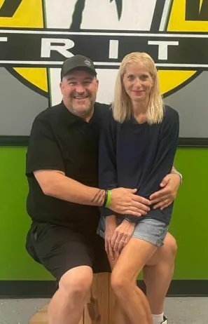 Mike and Paula Granam in front of the club wall.